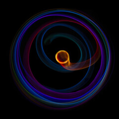 Abstract rotating neon lights texture with black empty copy space inside. colored rainbow rays in a circle and in a frame, on a black background, they are spinning multi-colored
