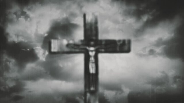 Jesus Christ crucified at Golgotha hill outside ancient Jerusalem. The crucifixion of Christ with stormy clouds in the sky. Vintage film look. 4K video