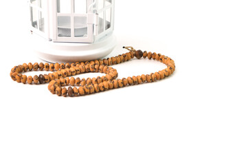 Islamic prayer beads and Ramadan lantern isolated on a white background. Ramadan kareem festive and Islamic holy month greeting