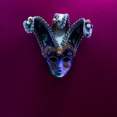 Masquerade mask with bells, with patterns and ornaments, embroidered with gold thread on a pink-purple background