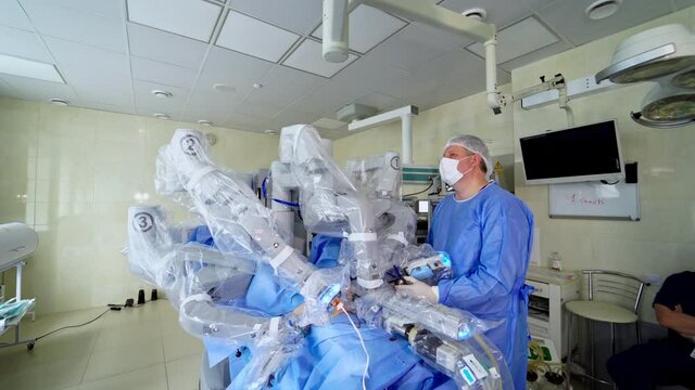 Medical surgical robot perform an operation. Robotic machine doing an operation using automated arms. Modern medical equipment with minimal invasive surgery. Doctors control the work of robotic machin