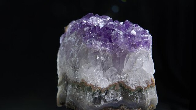Amethyst Close Up.  Close up view of an Amethyst  rock rotating in the dark background.