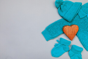 Baby concept. handmade knitted suit for baby on grey  background. Place for text. View from above. Flat Lay - Image