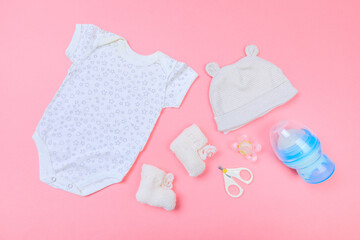 Baby concept. Baby cloth and goods on pastel pink background. Place for text. View from above. Flat Lay- Image