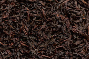Texture of rich black tea leaves as a background.