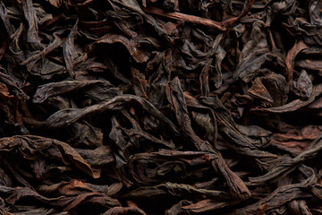 Black tea leaves texture as background.