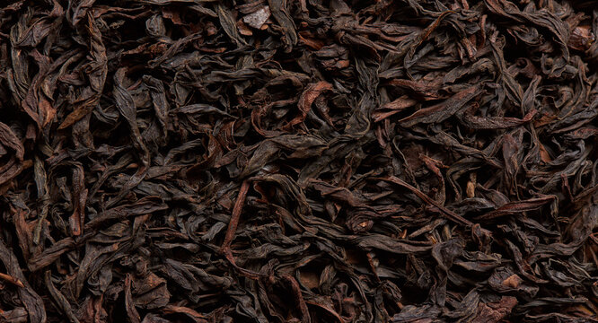 The texture of selected black tea leaves as a background.