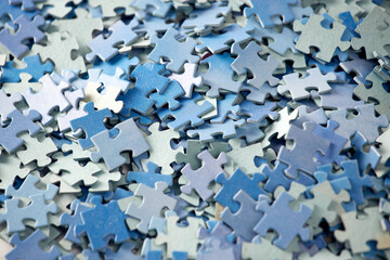 Jigsaw puzzle pieces in background. Close up