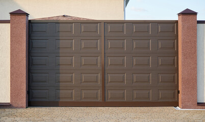 Modern brown PVC gates in a private house.