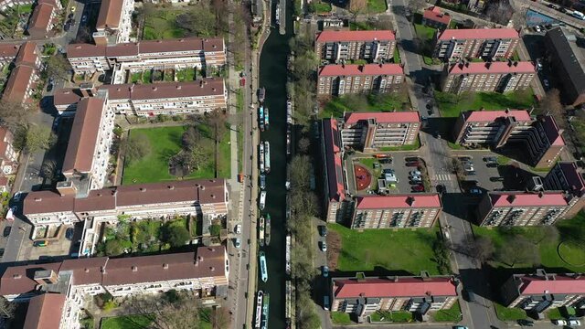 bird eye view of european residential community with river, moving cars and boads.