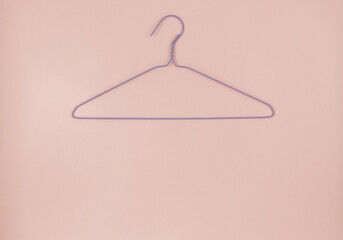 Metal pink hangers for clothes on pink background.  Empty cloth hanger template. Fashion blog,  sales,  store, online  shopping concept. 