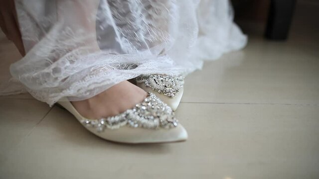 wedding shoes on the floor .Bride Putting On Shoes For Wedding Day