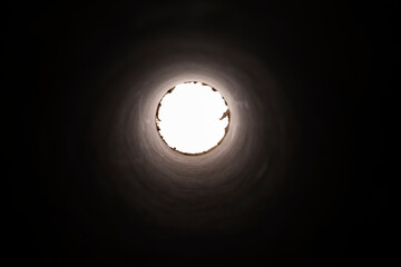 Abstract round spiral circular tunnel, view inside a tube, light at end of tunnel