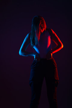 Blue And Red Light Portrait Of A Female Model On A Black Background With High Contrast