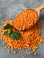red lentils, in a wooden spoon