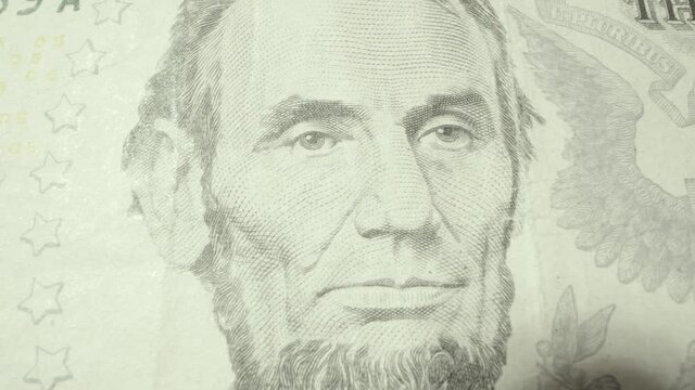 Close up of honest Abe 16th president of the United States of America portrait on the US 5 five dollar bill. Abraham Lincoln admired for leading the country through the civil war