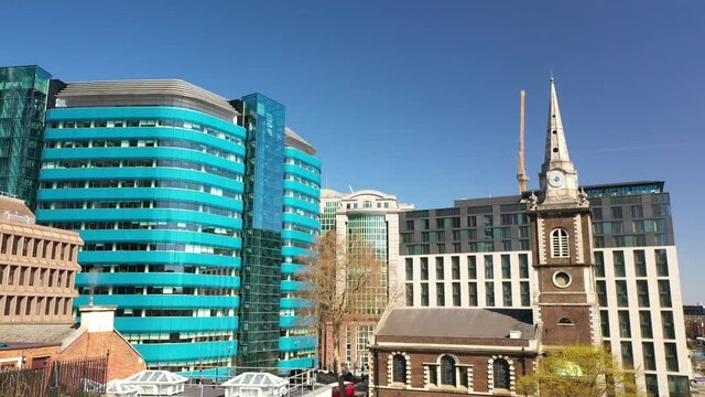 london central tilt down aerial of people sitting in a small public park, white Chapple, algate, liverpool street drone shot.