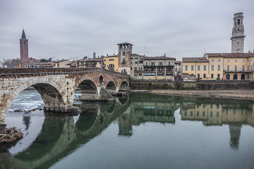 View of Stone Bridge (Ponte Pietra or Pons Marmoreus) - Roman arch bridge crossing the Adige River in Verona, Italy. The bridge completed in 100 BC, is the oldest bridge in Verona.