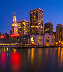 City  of San Francisco skyline at night with lights reflected in San Francisco Bay.