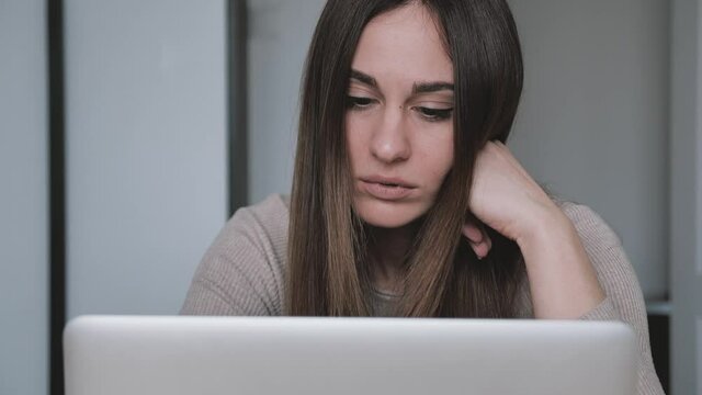 Woman headache is killing. Head shot close up stressed young woman looking screen of laptop think about correspondence. Frustrated female feeling a loser at home office. Problem at work