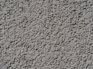 light grey rough grunge plaster with grain textured background