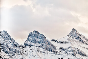 The snow topped Three Sisters and mountains surrounding Canmore Alberta at sunset