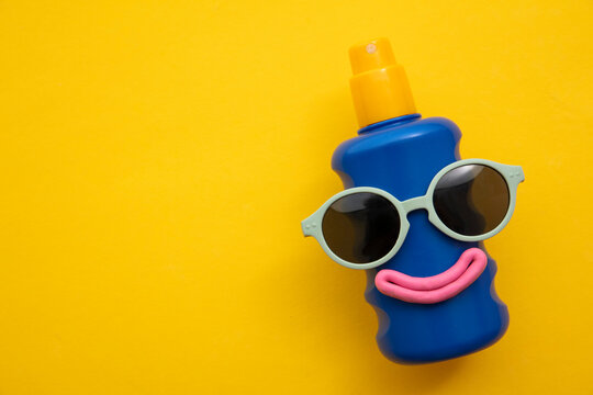 Happy Sun Block Bottle Wearing Sunglasses And A Smile On A Yellow Background