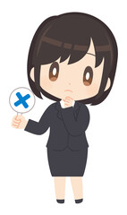 不正解のプラカードを持つビジネススーツ姿の女性