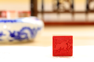 Naklejka na ściany i meble Chinese craftsman carving a stone seal