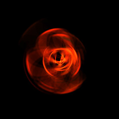 Spinning rays of light isolated on black background. Graphic 2D illustration of glowing colorful light particles in circular motion.