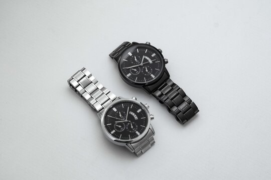Luxury black and silver watch on white table. Monochromatic concept. Complementary color concept.
