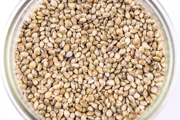Full frame Cannabis seeds in glass bowl isolated on white