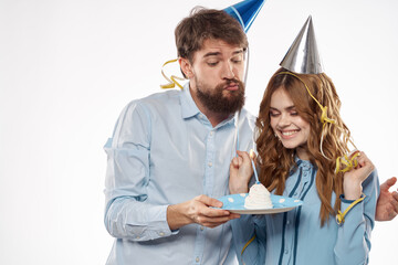Joyful man and cheerful Woman holiday cake Birthday cap party corporate party young people