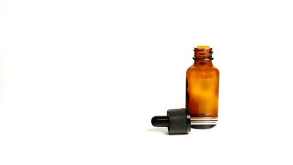 Brown glass bottles.A bottle with a pipette, isolated on a white background. glass container for cosmetic skin care products. Aromatherapy, essence, or perfume is empty. a bottle of cosmetic dropper. 