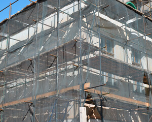 Fototapeta premium Construction work, reconstruction of an old building, restoration of the facade