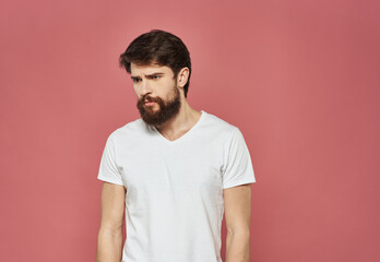 Man with sad face on pink background cropped view of white t-shirt