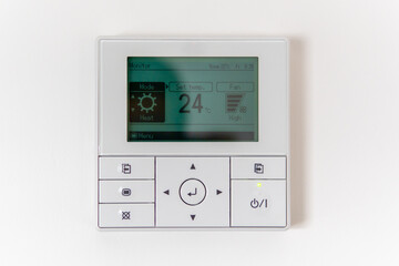 Air conditioning controller on the wall that shows an air temperature of 24 degrees Celsius