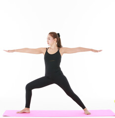 Asian woman doing yoga with outstretched arms