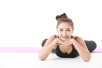 Fototapeta na wymiar Cheerful Asian female during yoga session