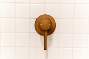 Hot and cold modern chrome shower handle valve in bathroom wall