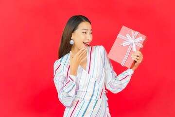 Portrait beautiful young asian woman with red gift box