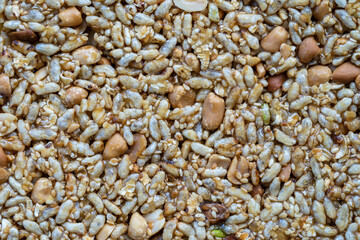 Granola bar. Healthy sweet dessert snack. Peanuts and rice with honey in background, close up
