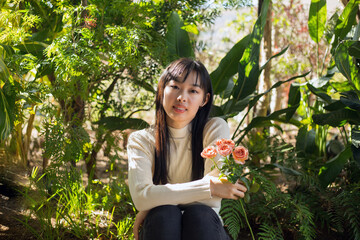 youbg Asian woman holding a flower