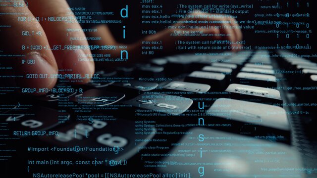 Creative visual of computer programming coding and software development shown by man working on computer keyboard with overlay of computer graphic displaying abstract program codes and computer script