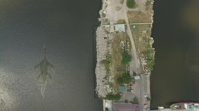 Aerial view. Dragon, monster of prehistoric era, floats underwater along coast river, yacht marine. Ness Monster