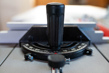 Miter gauge on professional table saw, focus on the scale, shallow depth of field.