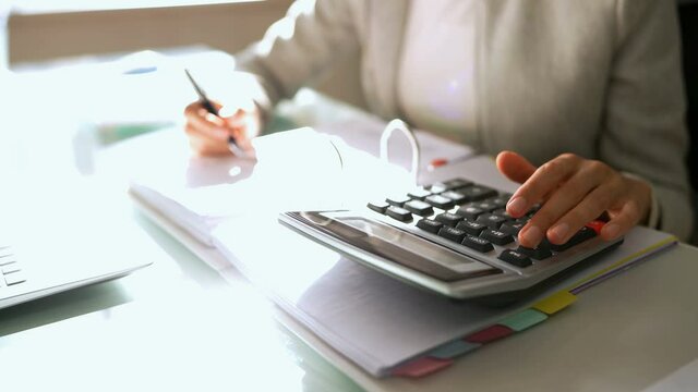 African Accountant Using Calculator