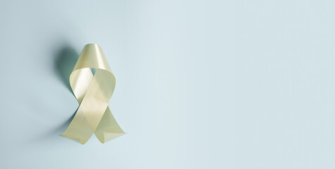 World cancer day, National cancer survivor day, cancer awareness, world autism awareness day, World Down Syndrome Day, yellow ribbons on pastel blue background	