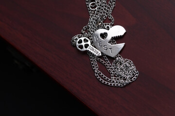 Pendant of best friends heart and key necklace silver color closeup. Selective Focus. High quality photo