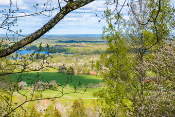 Beautiful view of a rural landscape in spring through tree branches
